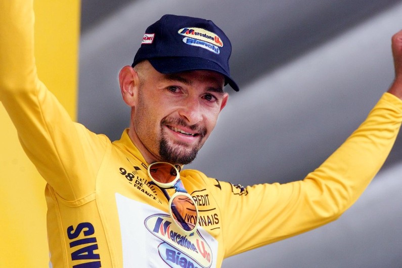 Marco Pantani climbing aggressively on a steep gradient