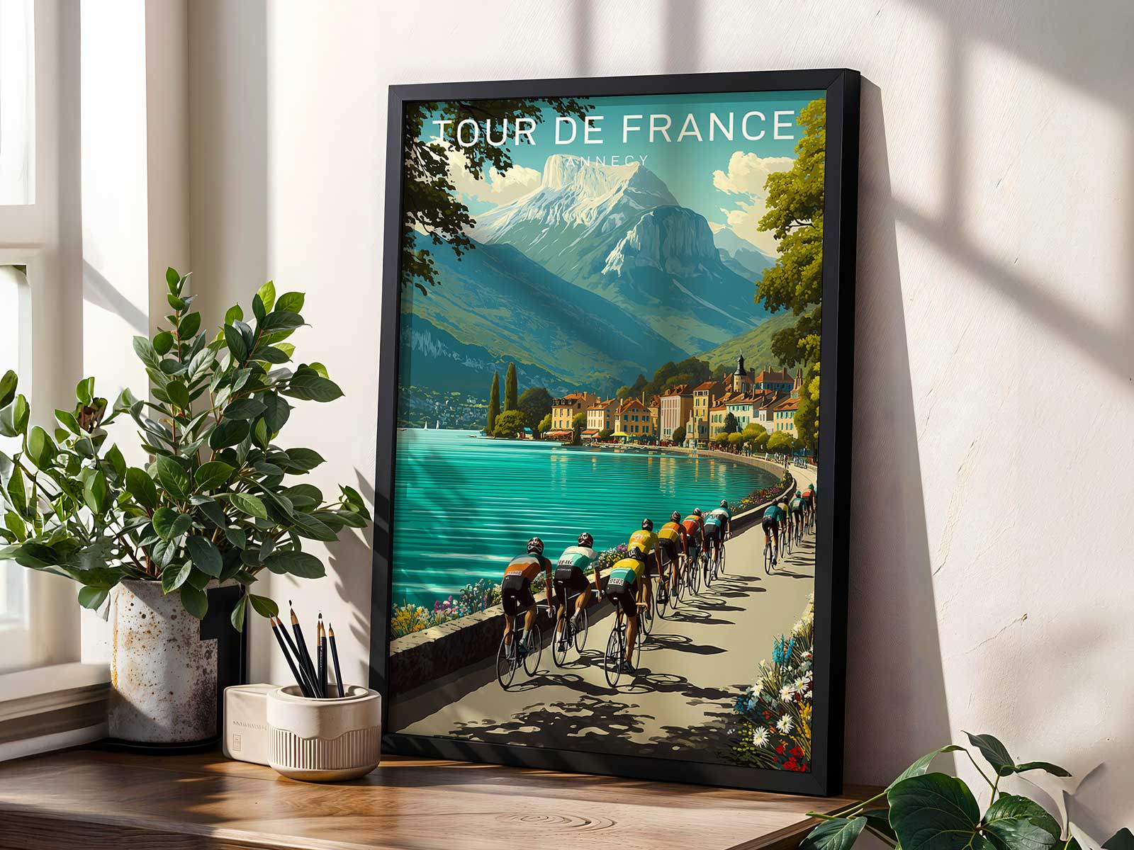 Vintage-style poster view of Lake Annecy with distant cyclists, soft alpine light and resort buildings along the shore