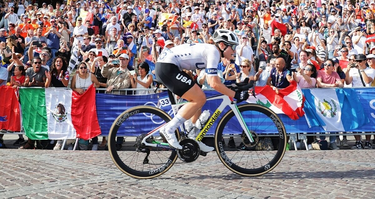 Riders climbing a steep mountain pass with spectators lining the road during a World Championships mountain stage