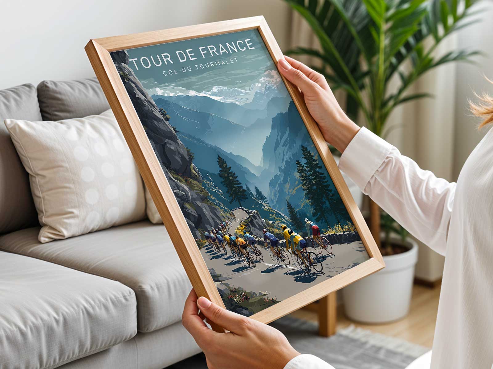 Close-up poster detail of a cyclist's strained posture and pedals against a blurred mountain backdrop on the Col du Tourmalet