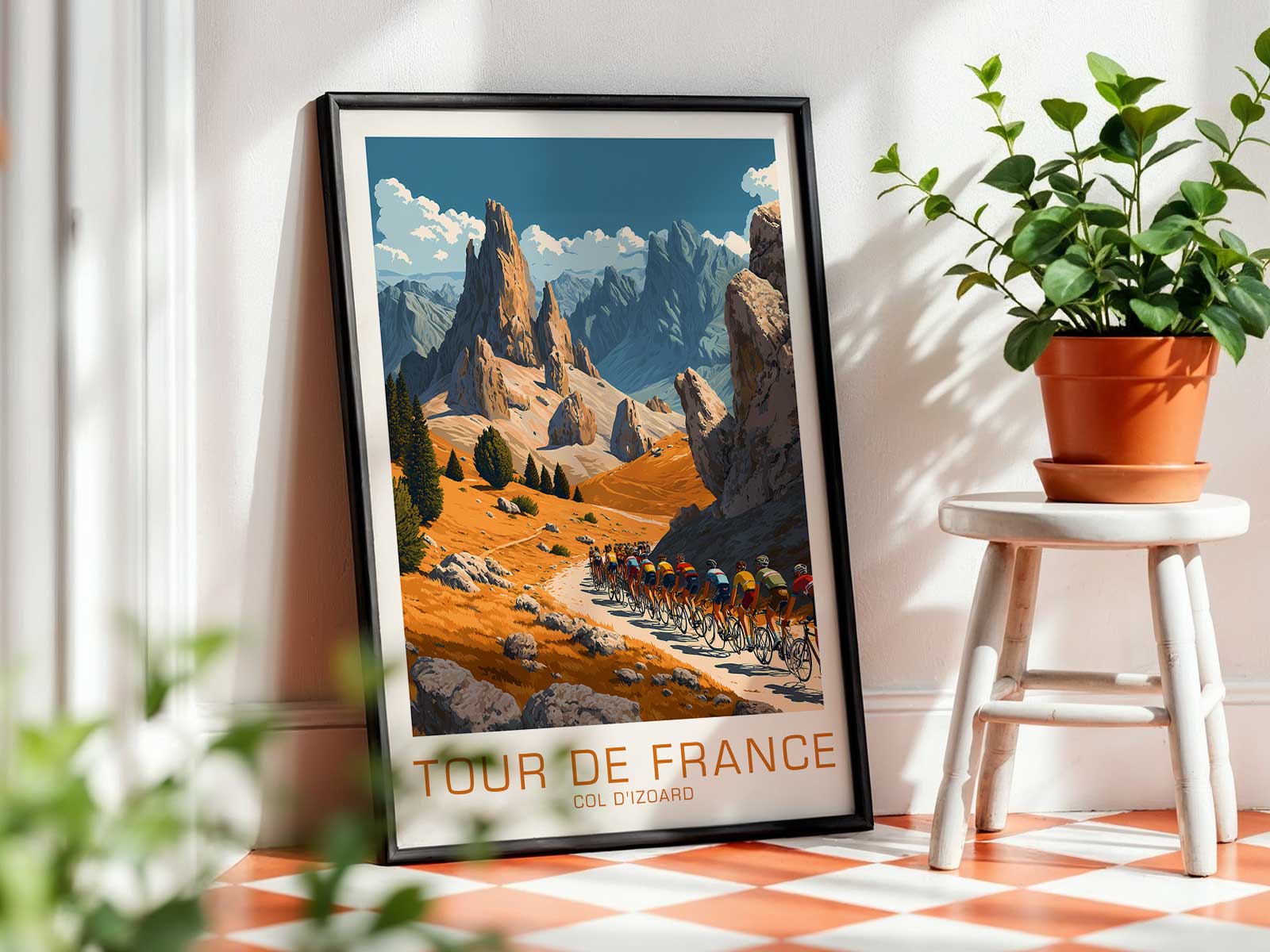 Framed vintage Col d'Izoard poster displayed on a living room wall above a sideboard