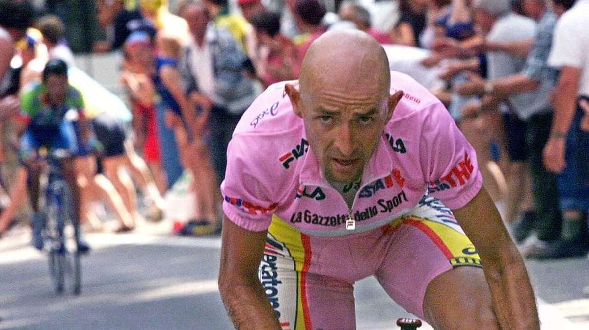 Marco Pantani on the 1998 podium celebrating his Giro–Tour double with raised arms and a laurel wreath