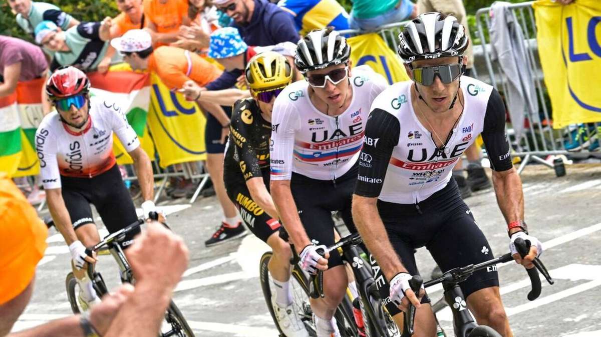 Narrow coastal road with barriers and a tight single-lane section creating a bottleneck on the stage 1 route